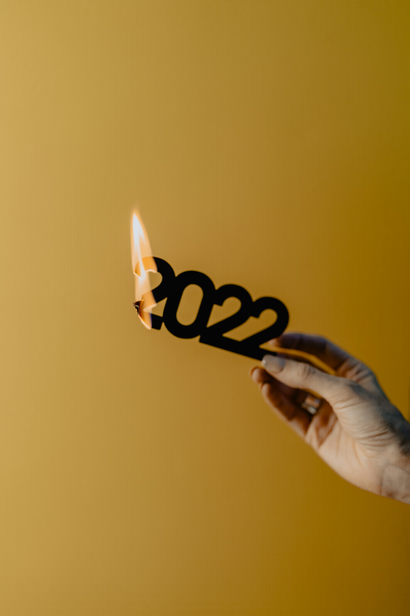 Hand holding a lit candle — Release and Burn ritual