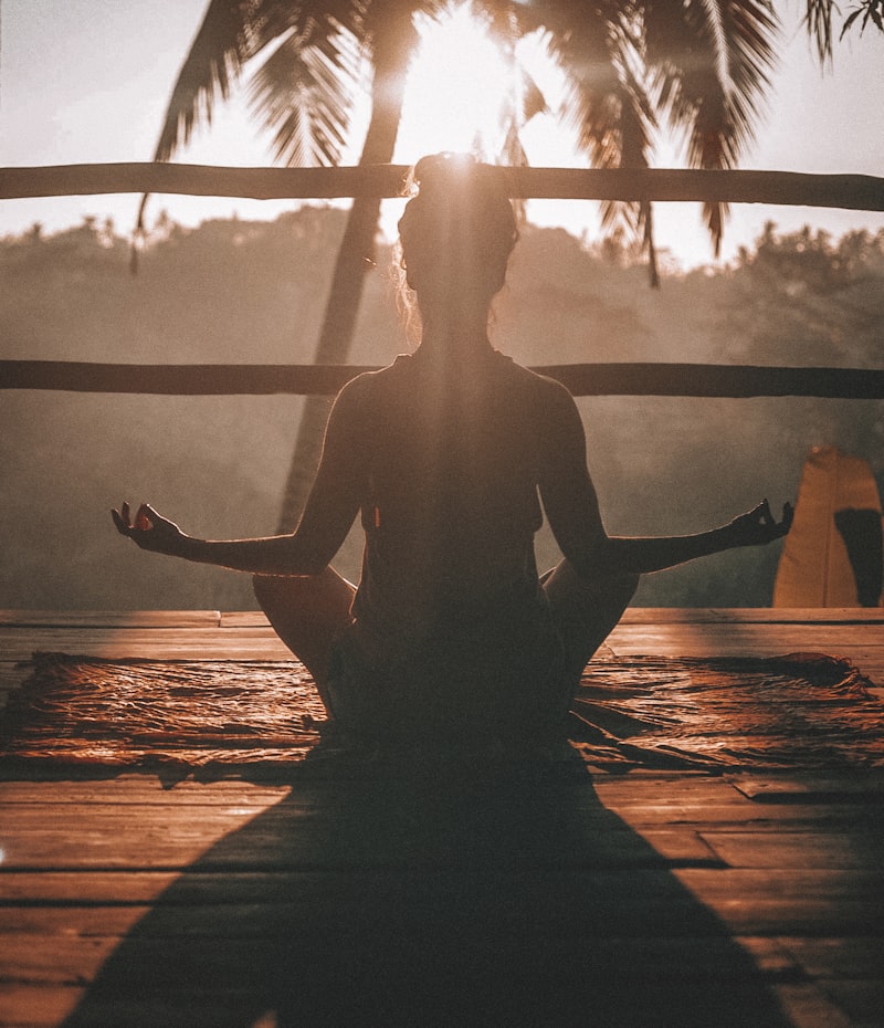 Person meditating peacefully in soft morning light