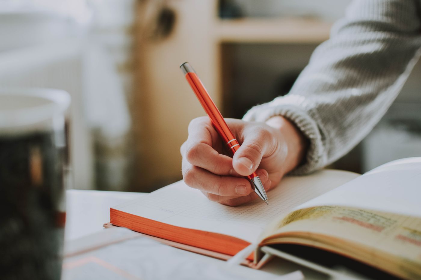 Woman writing at a desk — building a daily shadow work practice
